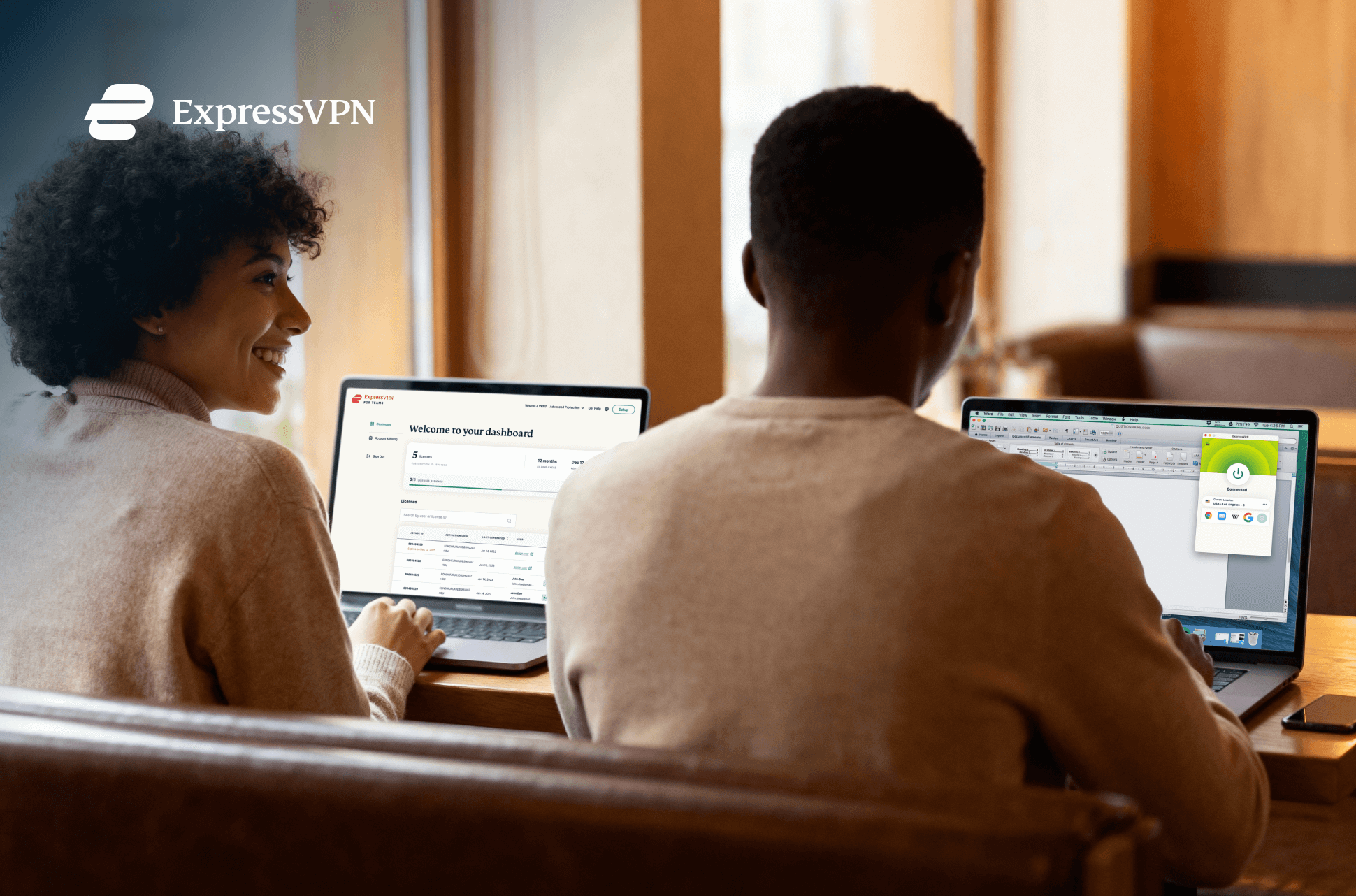 Two colleagues work side-by-side on devices securely using a VPN.